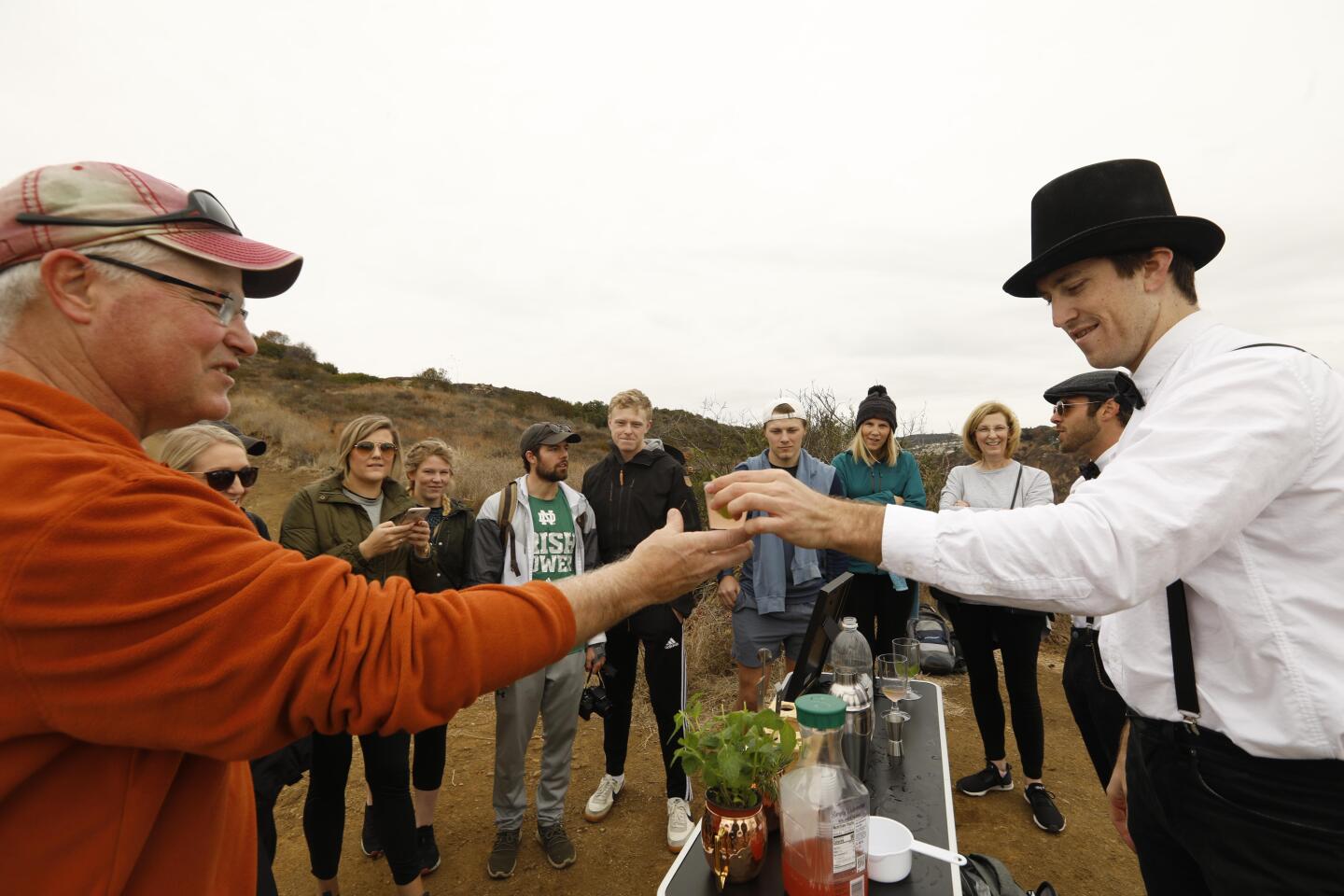 Weber hands a hiker a drink.