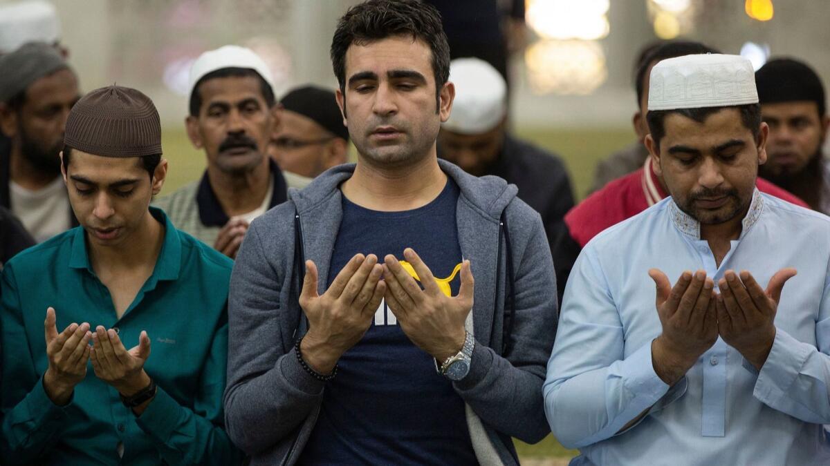 People pray at the Kowloon Mosque Tsim Sha Tsui in Hong Kong on Saturday for victims of the mosque attacks in Christchurch, New Zealand.