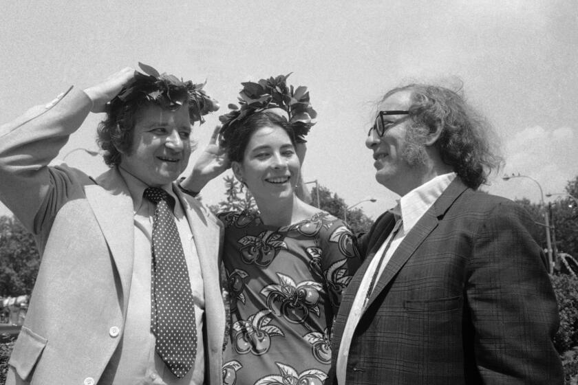 Dr. Isaac Asimov, right, chats with Novelist Dan Wakefield, Boston, and Writer and Crusader against population growth Stephanie Mills on August 1, 1974 in Berkeley, California., as the two hold laurels after being crowned "Nonparents of the Year." The couple was honored at New York's Central Park during "Nonparents Day" ceremonies, which extolled childless families. No storks were to be seen. (AP Photo)