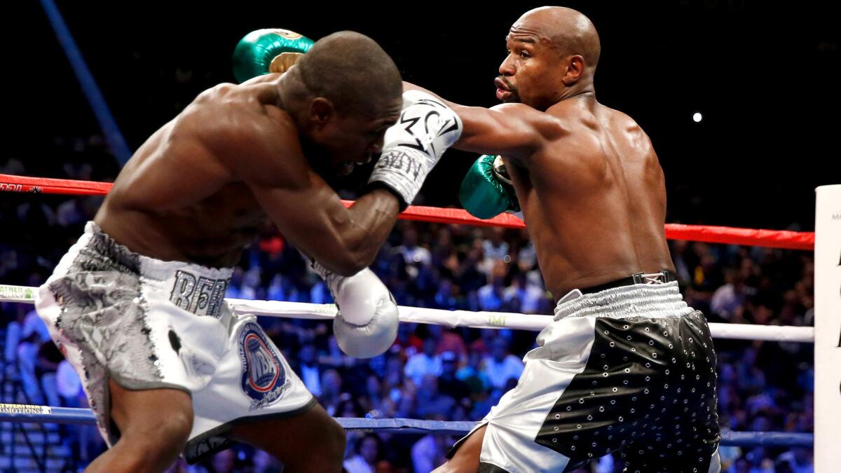 Andre Berto tries to block a left jab from Floyd Mayweather Jr. during their welterweight title fight on Saturday night at the MGM Grand Garden Arena.