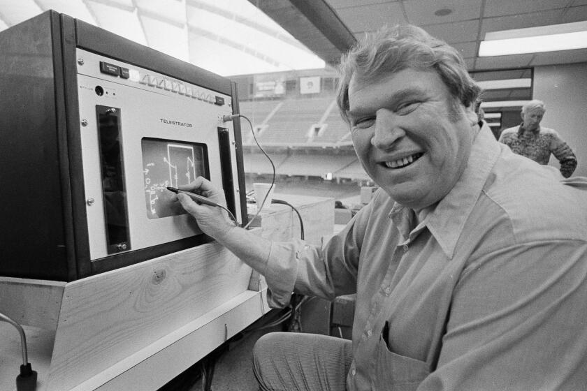 FILE - Former Oakland Raiders coach John Madden practices the electronic charting device Telestrator on Jan. 21, 1982, in Pontiac, Mich., for the upcoming NFL football Super Bowl broadcast on CBS. Madden, the Hall of Fame coach turned broadcaster whose exuberant calls combined with simple explanations provided a weekly soundtrack to NFL games for three decades, died Tuesday morning, Dec. 28, 2021, the league said. He was 85. The NFL said he died unexpectedly and did not detail a cause. (AP Photo, File)