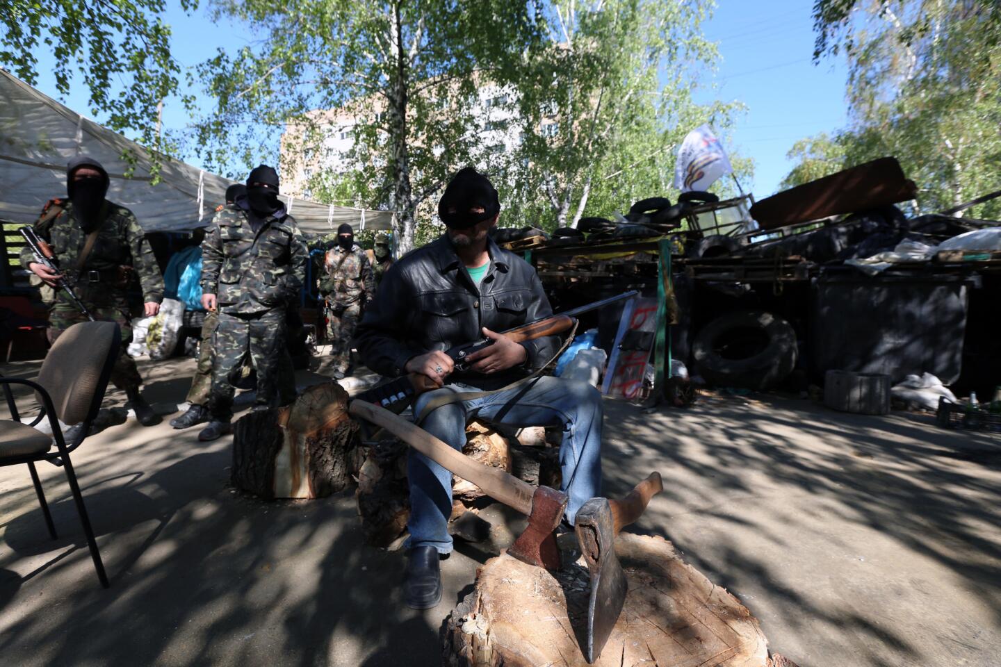 Separatist gunmen man one of the bases in front of the police station they captured this month in Slovyansk, Ukraine.