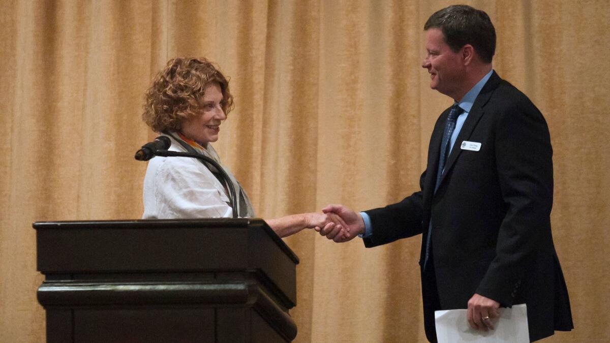 Laguna Beach Mayor Toni Iseman, left, greets City Manager John Pietig at the State of the City luncheon Monday at the Montage Laguna Beach. Iseman and Pietig noted challenges facing the city such as traffic and parking.