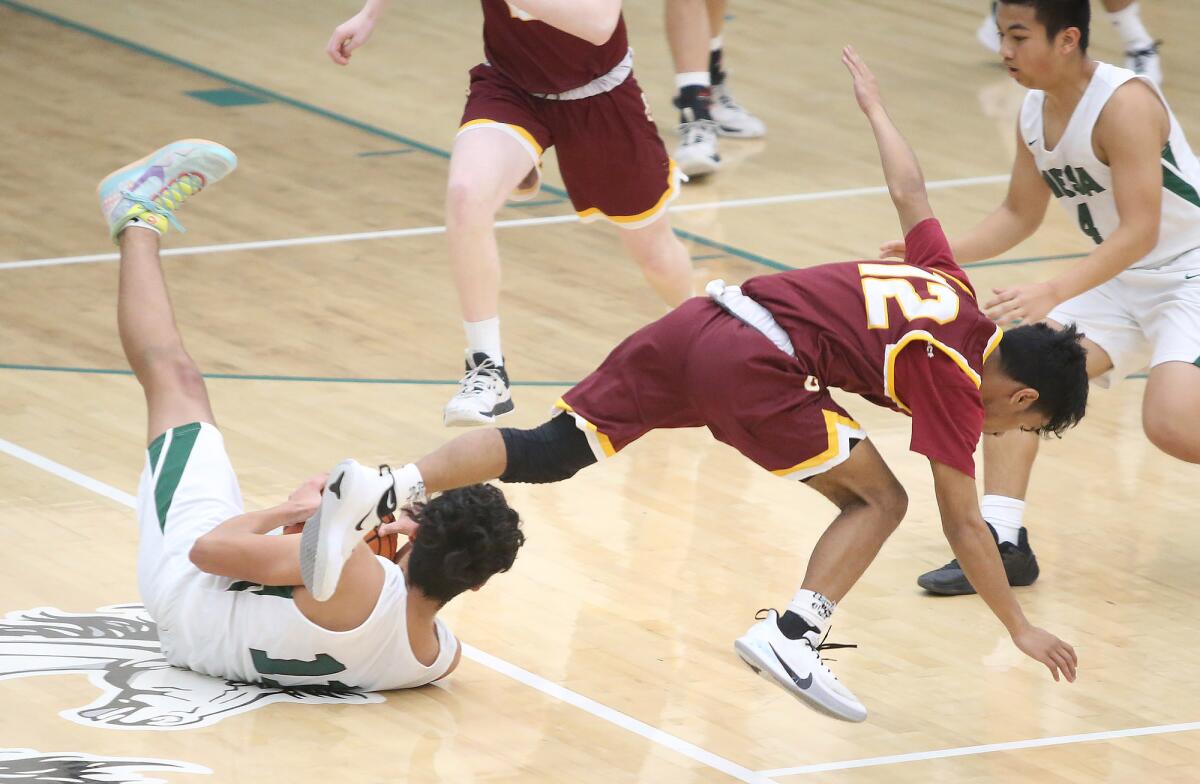 Marvin Harry (12), shown hitting the floor for a loose ball in a Jan. 15 game against Costa Mesa, had three points in the Eagles' 49-46 loss at Bishop Diego on Tuesday in the quarterfinals of the CIF Southern Section Division 5AA playoffs.