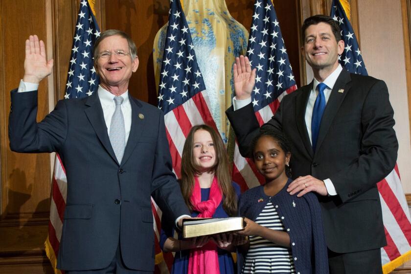 Rep. Lamar Smith (R-Texas), left, is sworn in to his new term by House Speaker Paul Ryan in January. Oil and gas contributors have directed nearly $700,000 in Smith’s direction since he entered in Congress in 1987.