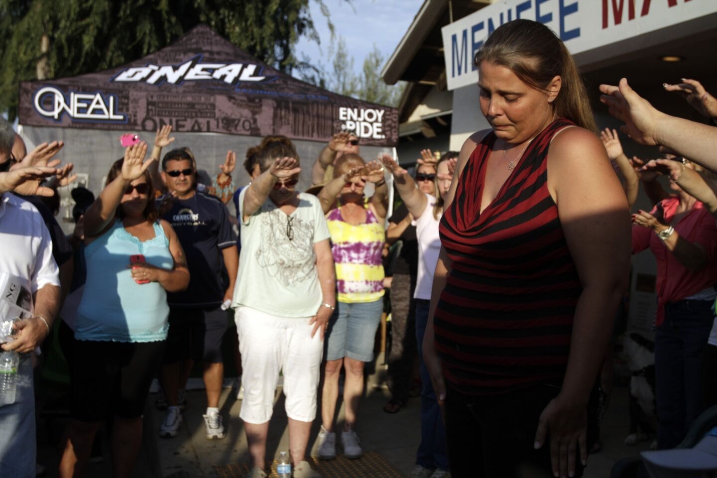 Becca Smith, the mother of Terry Dewayne Smith, is surrounded by friends and neighbors during a prayer session at the volunteer center in Menifee. Terry Dewayne Smith, an 11-year-old autistic boy remains missing, despite the efforts of more than 100 volunteers and emergency workers who combed the hills of Menifee looking for the child.