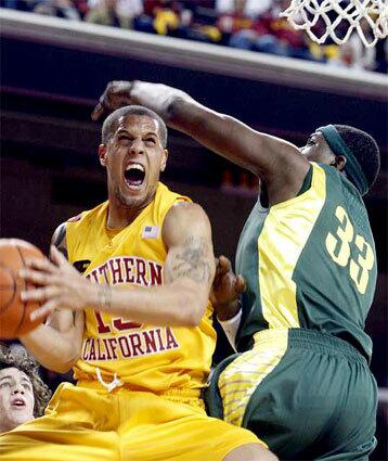 USC guard Daniel Hackett goes for a layup against Oregon center Michael Dunigan in the first half Thursday night.