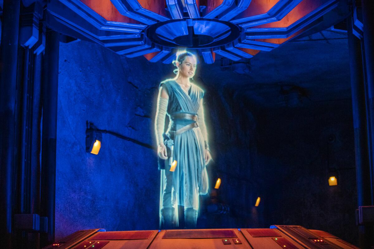 A Rey hologram materializes during the media preview of Star Wars: Rise of the Resistance at the Disneyland Resort 