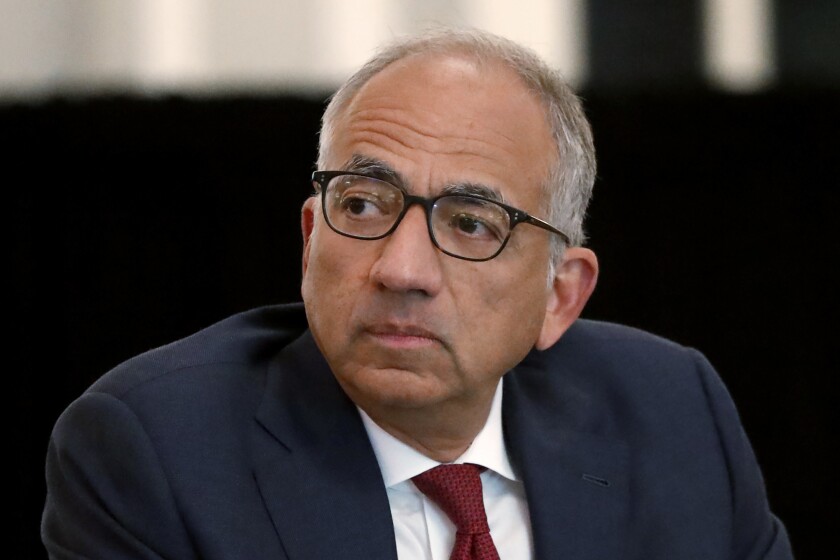 FILE -FILE - U.S. Soccer President Carlos Cordeiro presides over a meeting of the U.S. Soccer Board of Directors in Chicago, Dec. 6, 2019. Cordeiro is running to regain his job as U.S. Soccer Federation president, two years after he quit during a backlash after the group’s lawyers filed legal papers claiming the women’s national team players had less physical ability and responsibility than their male counterparts. (AP Photo/Charles Rex Arbogast, File)