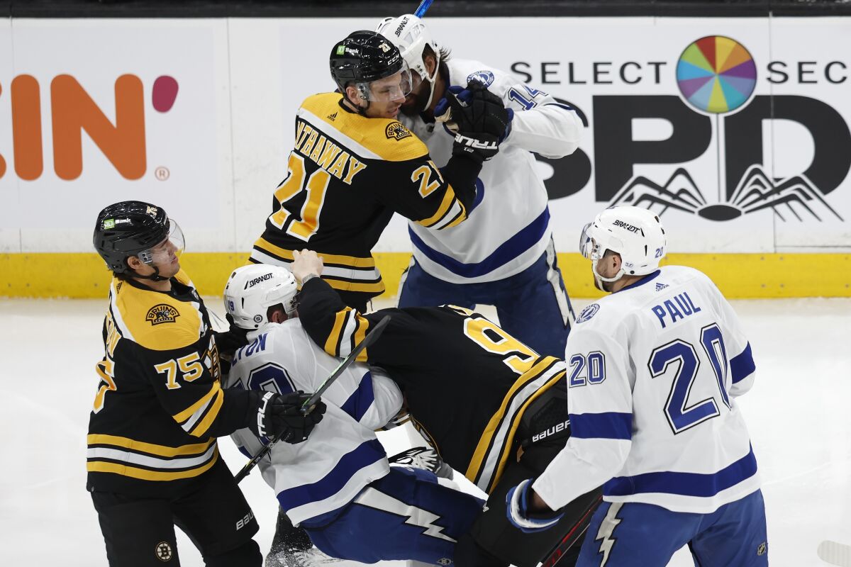 Boston Bruins' Garnet Hathaway (21), Tampa Bay Lightning's Pat Maroon, top right, Bruins' Jakub Lauko, center right, and Lightnings' Ross Colton, center left, fight during the first period of an NHL hockey game, Saturday, March 25, 2023, in Boston. (AP Photo/Michael Dwyer)