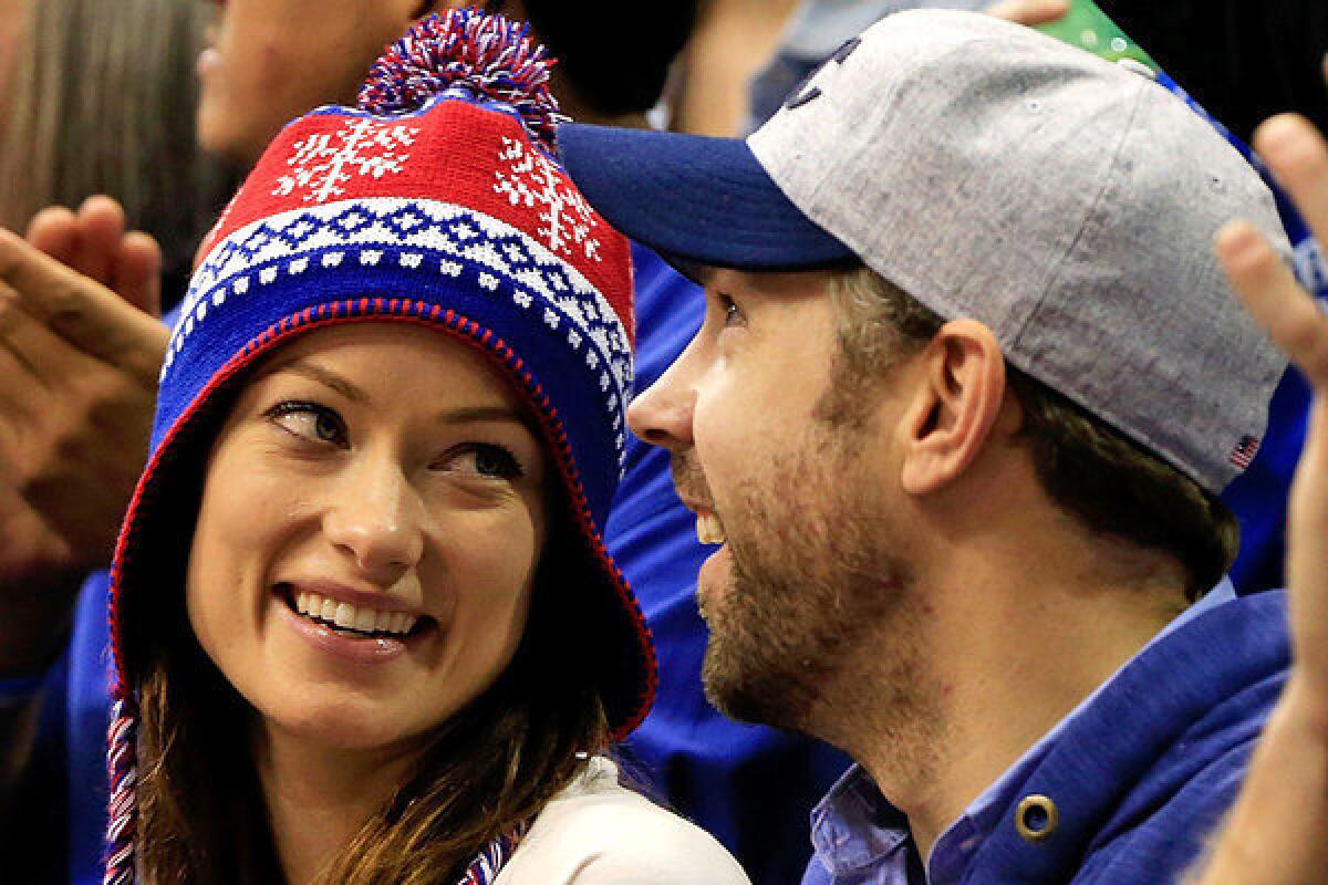 Olivia Wilde and Jason Sudeikis attend a Kansas University basketball game in Lawrence, Kan.