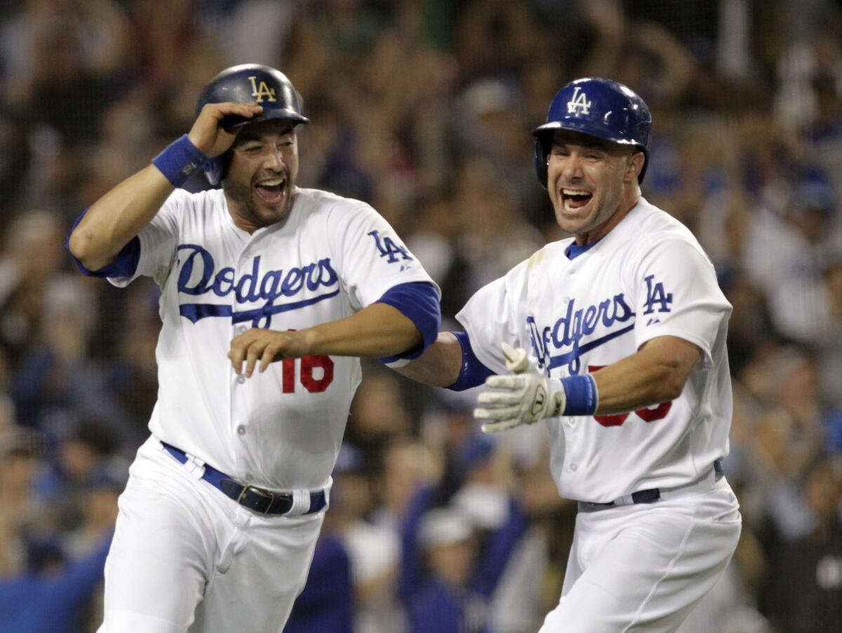 Andre Ethier, left, celebrates with teammate Skip Schumarker after scoring on Mark Ellis' walk-off single in the ninth inning of the Dodgers' 3-2 win over the New York Yankees on Tuesday night.