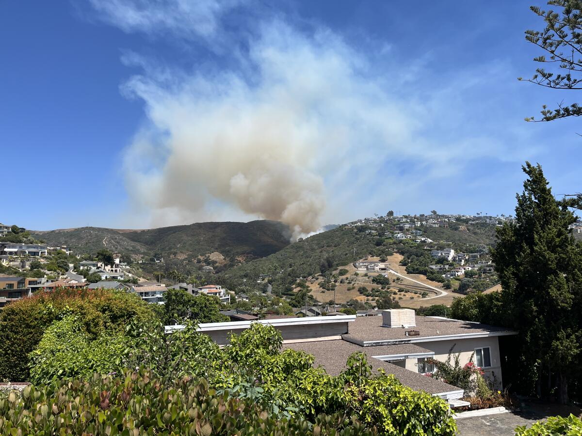 Firefighters are battling a 4-acre brush fire in Laguna Beach that broke out Monday, prompting the evacuation of residents.