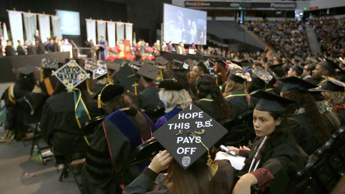 A message adorns a students mortarboard during graduation ceremonies from California State University, Sacramento, in Sacramento, Calif. on Dec. 17, 2016.
