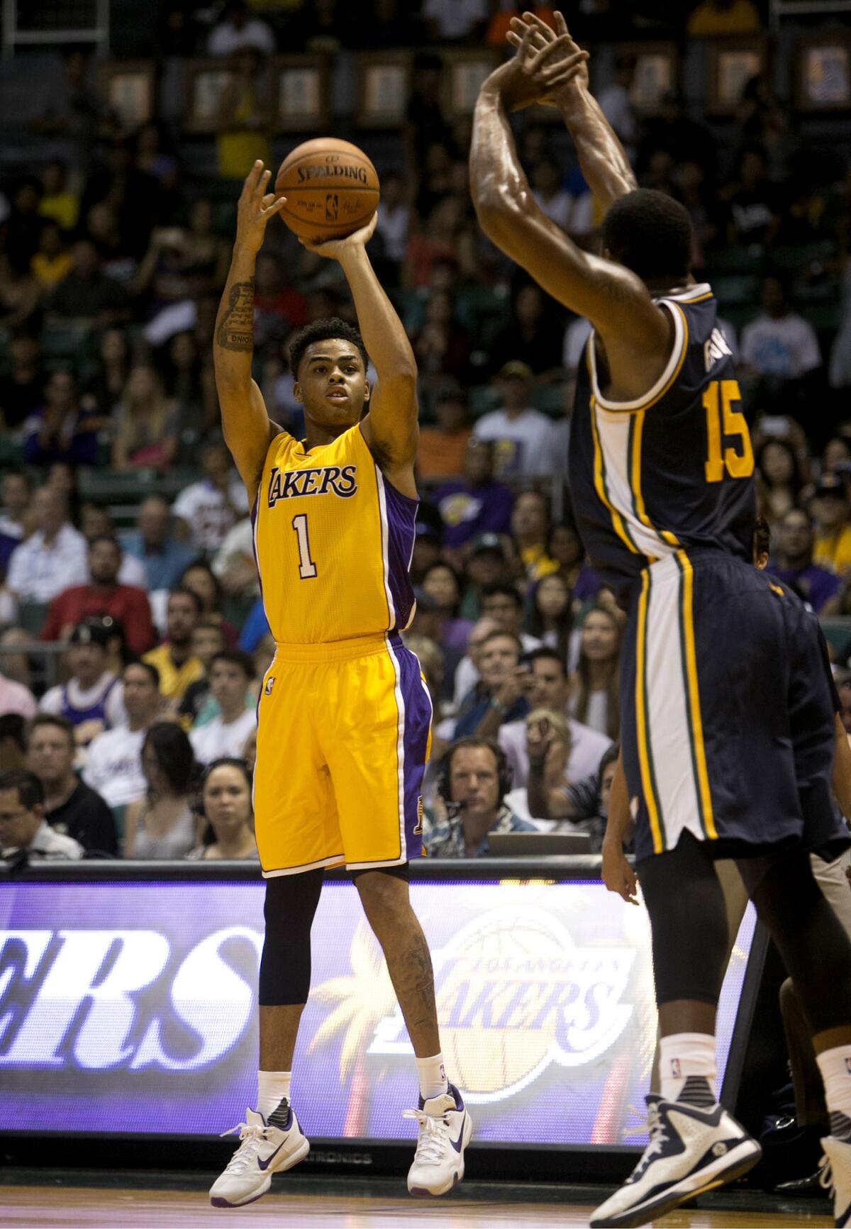 Los Angeles Lakers guard D'Angelo Russell (1) attempts a shot over Utah Jazz forward Derrick Favors (15) during the first quarter of a preseason NBA basketball game on Sunday in Honolulu.