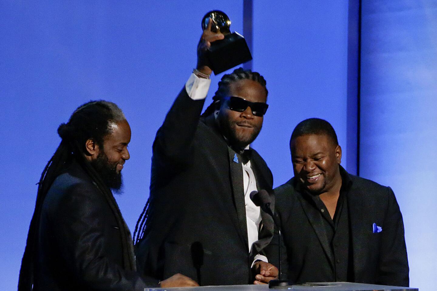 Musicians Peter "Peetah" Morgan, left, Roy "Gramps" Morgan and Nakamyah "Lukes" Morgan of Morgan Heritage accept the award for reggae album for "Strictly Roots" at the pre-telecast show.