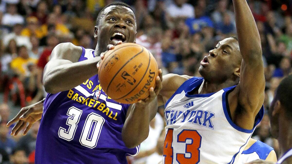 Lakers forward Julius Randle, driving past the Knicks’ Thanasis Antetokounmpo during a game July 13 in Las Vegas, has used his size and quickness to average 11.7 points and 3.7 rebounds in 20 minutes or less a game in the summer league.