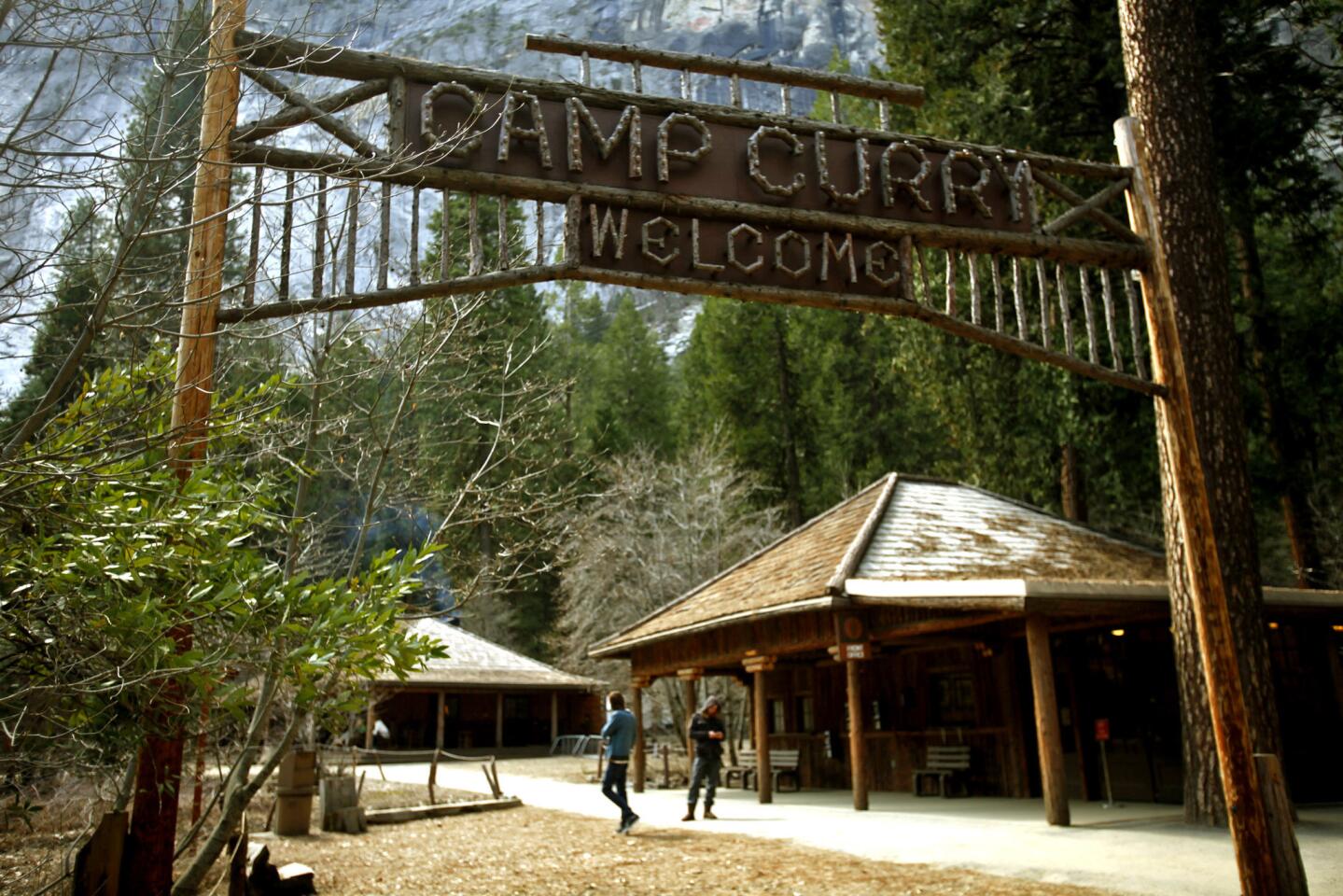 The historic wood sign at Camp Curry greets visitors at the famous lodging site in Yosemite. Construction and mitigation measures are progressing at Camp Curry, a year after hantavirus sickened and killed several visitors staying in some of the signature tent cabins.