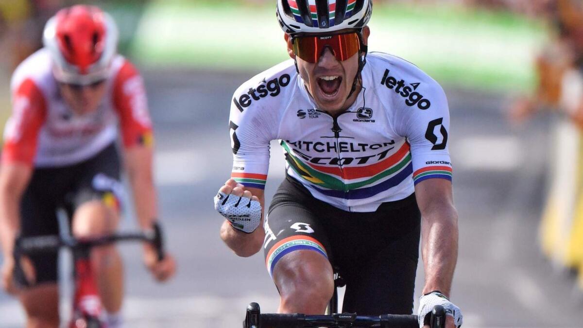 Daryl Impey celebrates as he cross the finish line for the ninth stage of the Tour de France ahead of Tiesj Benoot on Sunday.