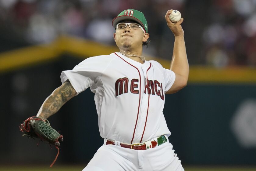 Mexico pitcher Julio Urías throws against Colombia during the first inning.