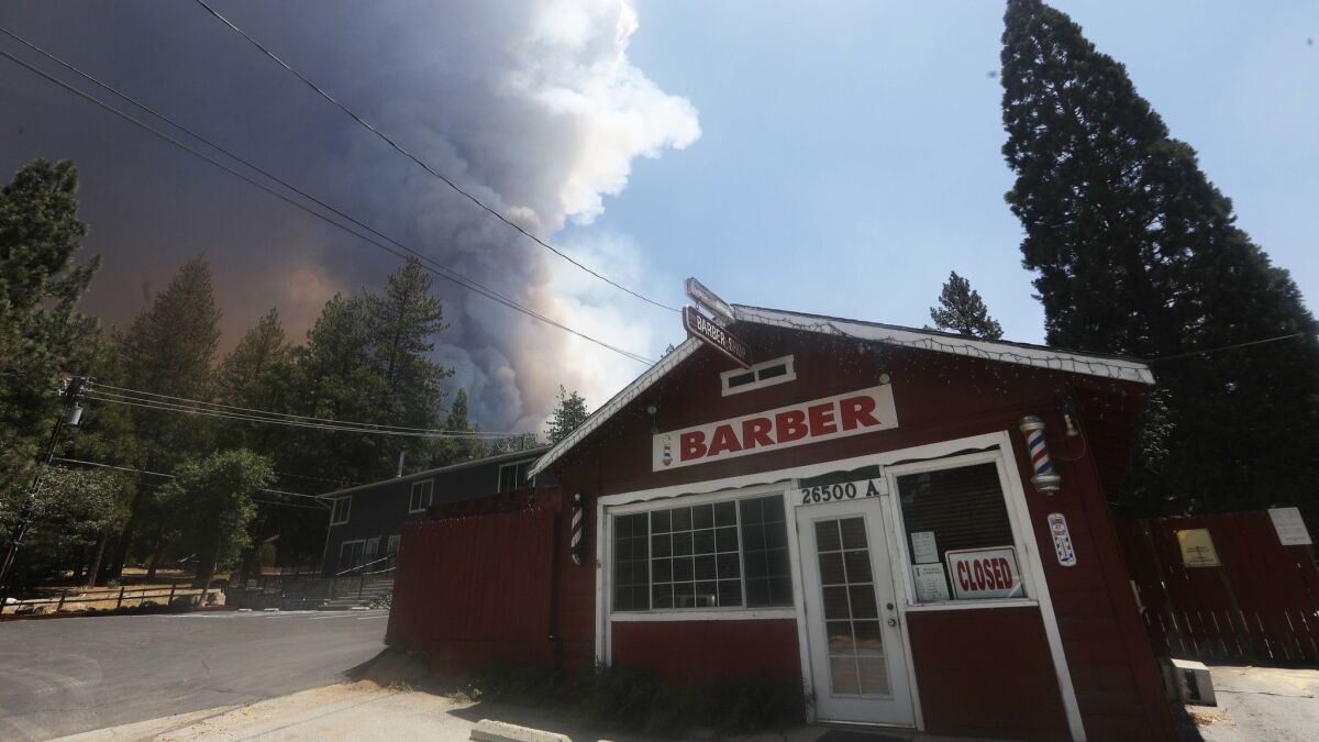 The Cranston fire burns close to a barbershop near Idyllwild on July 26.