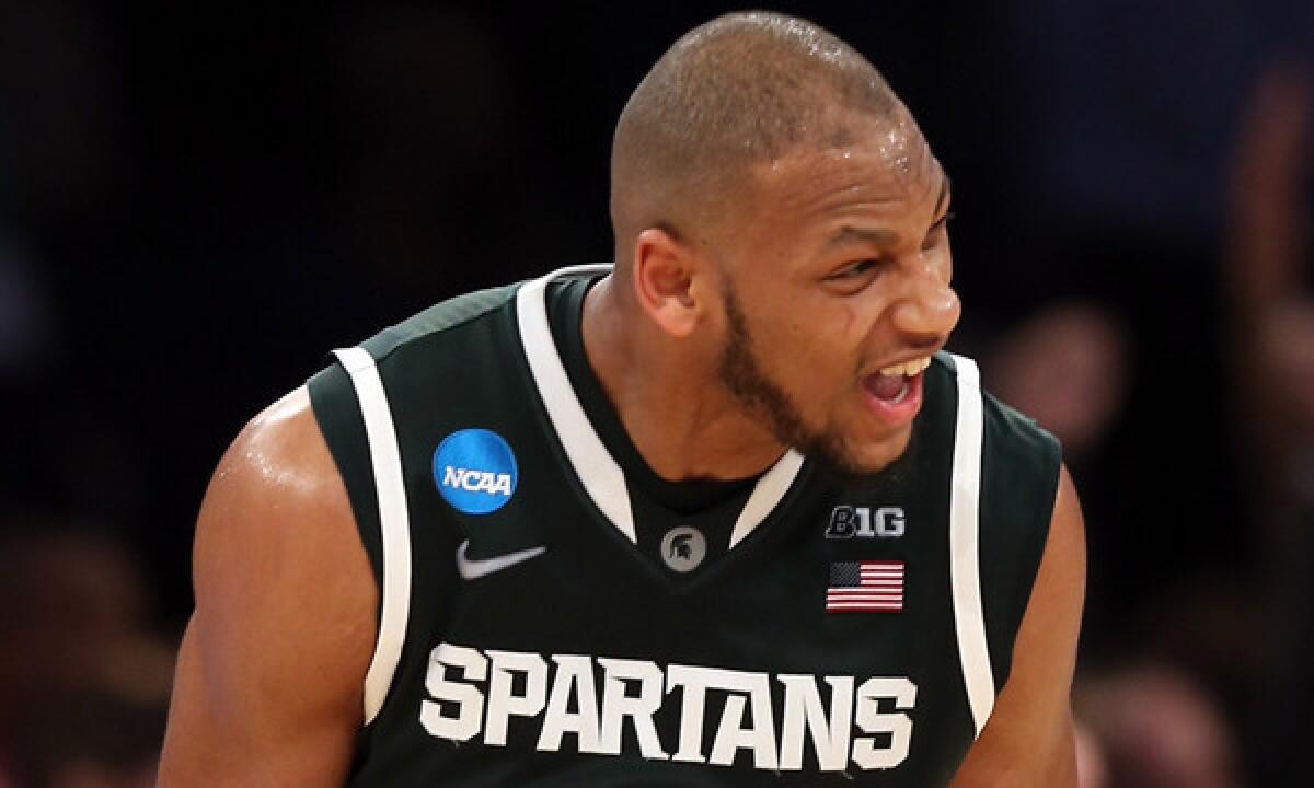 Michigan State's Adreian Payne celebrates after hitting a basket during the Spartans' NCAA tournament win Friday over top-seeded Virginia.