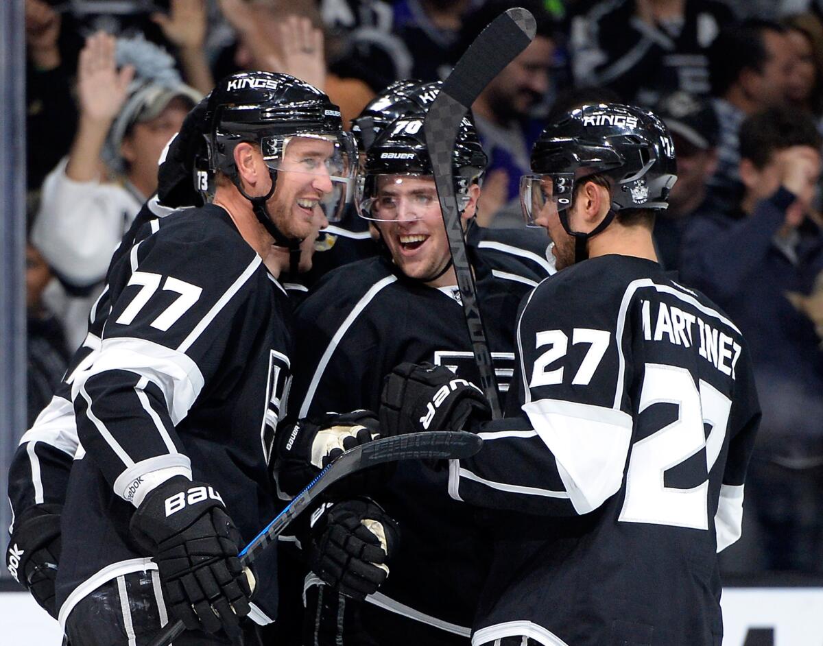 Tanner Pearson, center, celebrates his goal with Jeff Carter, left, and Alec Martinez during the Kings' 4-1 victory over Winnipeg on Sunday.