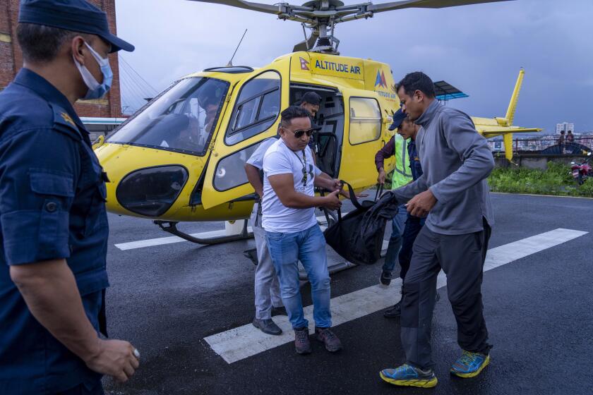 People carry a body of a victim of a helicopter crash arrive in Kathmandu, Nepal, Tuesday, July 11, 2023. Five Mexican tourists and a Nepalese pilot have died when it crashed near Mount Everest in Nepal. The aircraft was returning to Kathmandu after bringing the five tourists on a sightseeing trip to the world’s highest peak. (AP Photo/Niranjan Shrestha)