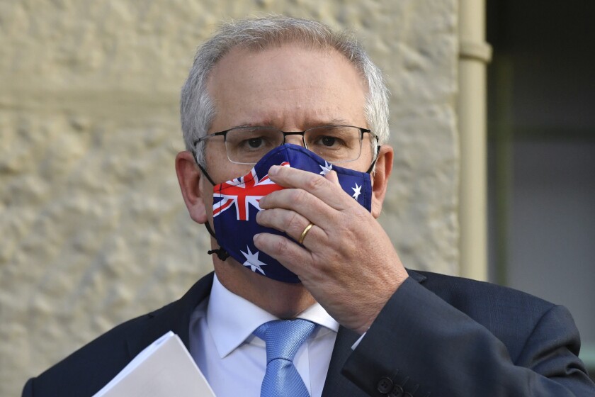 Australian Prime Minister Scott Morrison adjusts his mask during the announcement of a COVID-19 financial support package in Sydney, Tuesday, July 13, 2021. Morrison announced added financial support for businesses and households as Sydney appears increasingly likely to enter a fourth week of lockdown due to coronavirus clusters. (Mick Tsikas/AAP Image via AP)