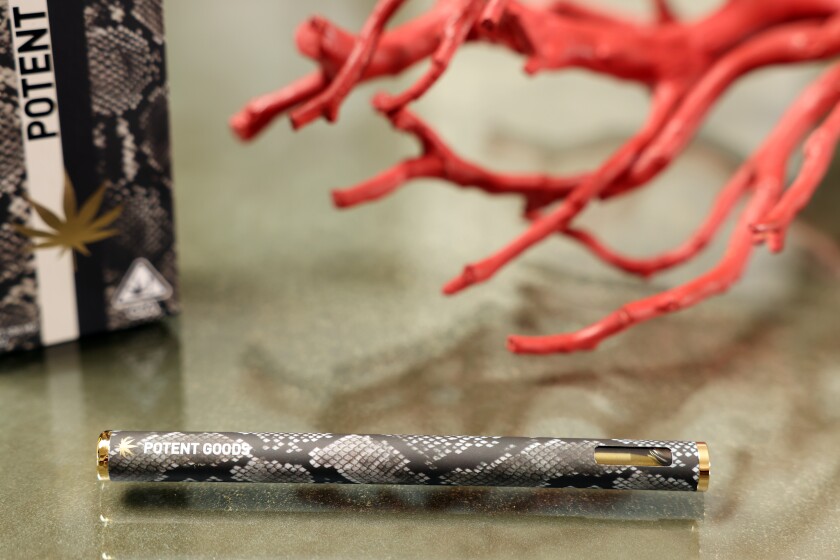 A pen-shaped, snakeskin-print vaporizer pen.