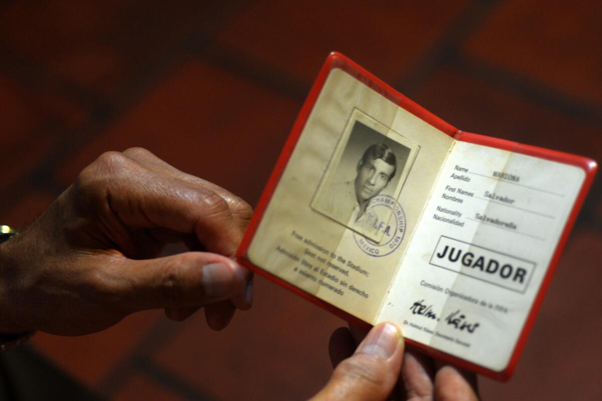 Salvador Mariona displays his participation card for the 1970 World Cup in Mexico.
