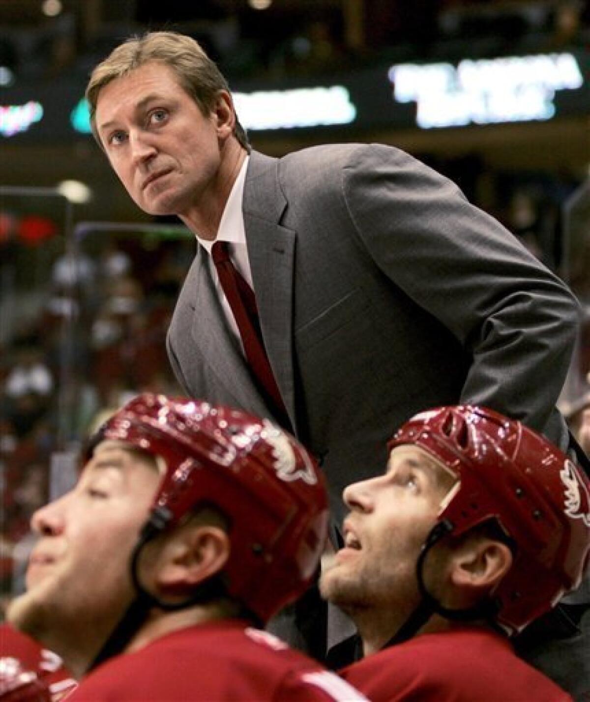 ADVANCE FOR WEEKEND, FEB. 16-17 ** Phoenix Coyotes associate coach Rick  Tocchet, top right, confers with coach Wayne Gretzky, top left, during the  Coyotes' NHL hockey game against the Dallas Stars