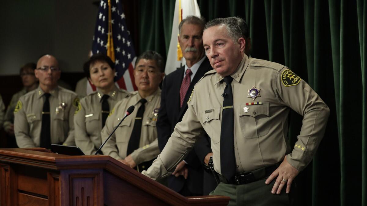 L.A. County Sheriff Alex Villanueva, shown at a Jan. 30 news conference, has defended his decision to rehire fired deputies.