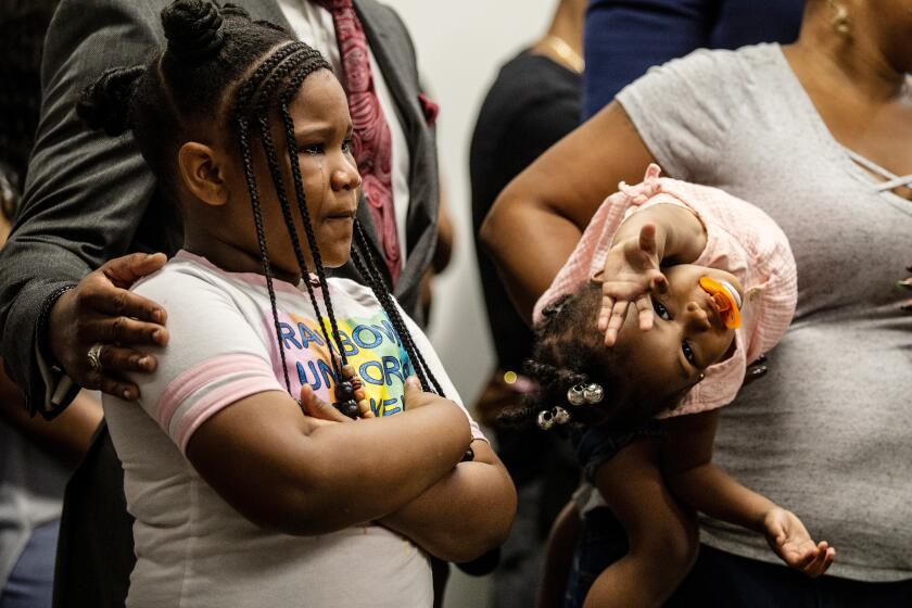 Blessen Miller, 8, left, and her sister, Memory, are seen at a news conference held by members of Rayshard Brooks' family on Monday, June 15, 2020, in Atlanta. The Brooks family and their attorneys spoke to the media days after Brooks was shot and killed by police at a Wendy's restaurant parking lot in Atlanta. (AP Photo/Ron Harris)