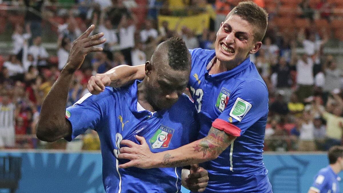 Italy's Mario Balotelli, left, celebrates with teammate Marco Verratti after scoring his second goal in a World Cup match against England on June 14. Italy hopes to have Verratti back on the field for Tuesday's game against Uruguay.