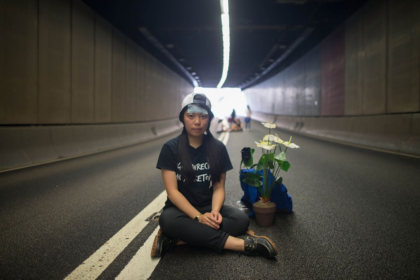 A protester sits in the middle of a tunnel in Central on Monday in Hong Kong.