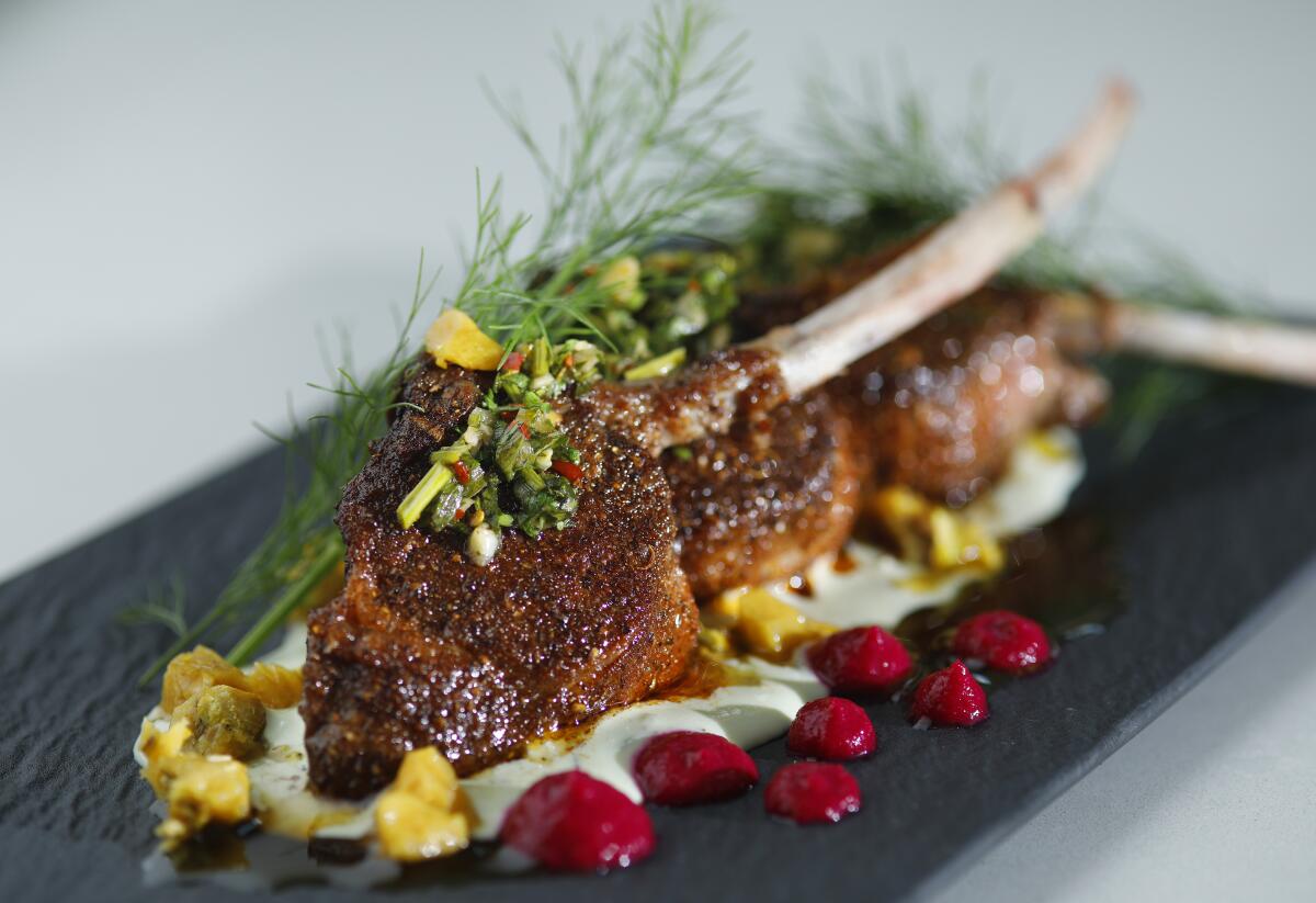 Grilled lamb chops are coated with a Moroccan spice mixture and served on a bed of tzatziki.