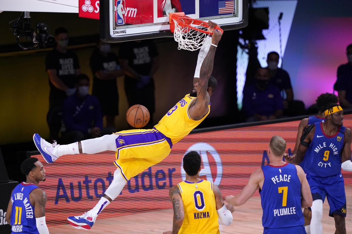 Lakers forward LeBron James dunks the ball during the second quarter of Game 1.