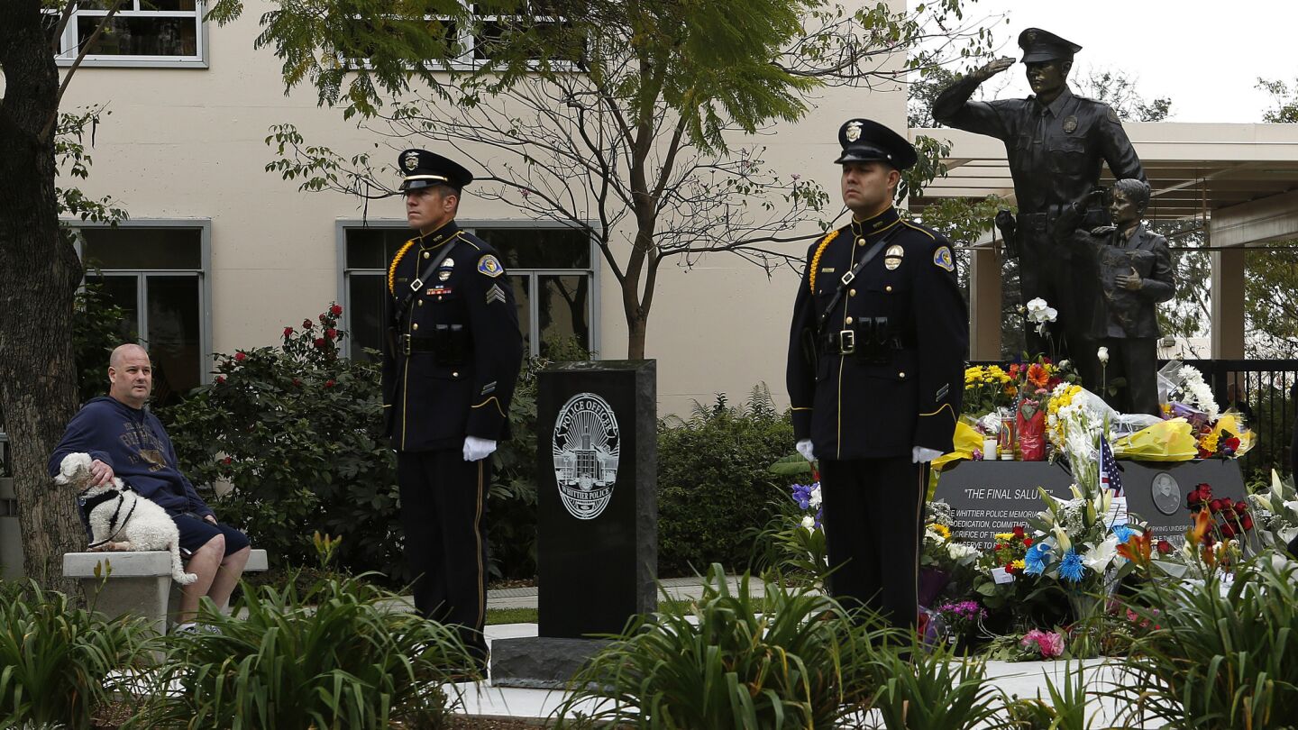 The Honor Guard stands at the memorial for fallen officers at the Whittier Police Department before a press conference.