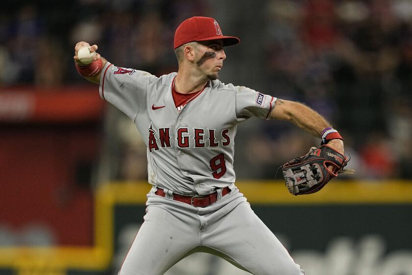 Los Angeles Angels shortstop Zach Neto throws to first base during the eighth inning of a baseball game.