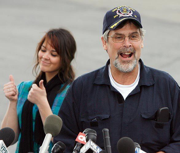 Capt. Richard Phillips smiles after arriving on a plane in South Burlington, Vt., Friday, April 17, 2009. Phillips is back in his home state, a week and a half after being taken hostage by pirates and then being rescued by Navy snipers. At rear is Phillips ' daughter, Mariah.