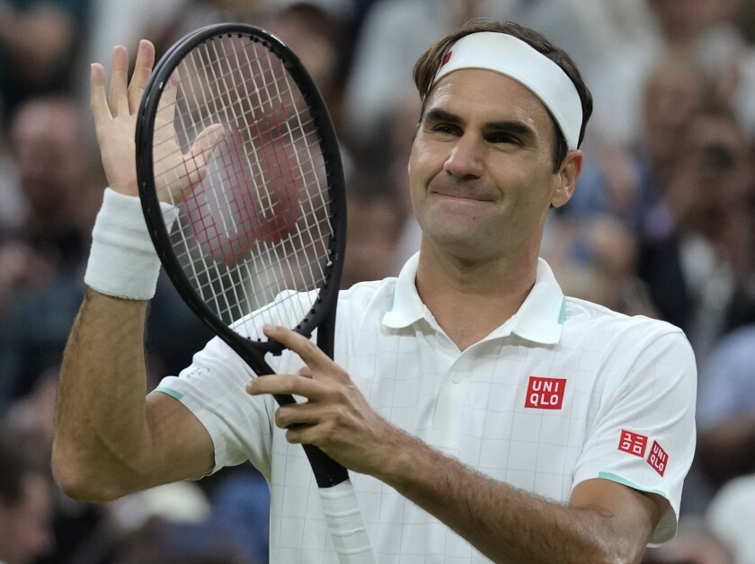 Switzerland's Roger Federer celebrates after defeating Italy's Lorenzo Sonego during the men's singles fourth round match on day seven of the Wimbledon Tennis Championships in London, Monday, July 5, 2021. (AP Photo/Kirsty Wigglesworth)