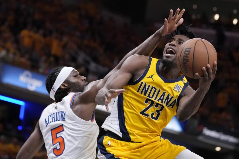 Indiana Pacers forward Aaron Nesmith (23) shoots over New York Knicks forward Precious Achiuwa (5) during the second half of Game 6 in an NBA basketball second-round playoff series, Friday, May 17, 2024, in Indianapolis. (AP Photo/Michael Conroy)