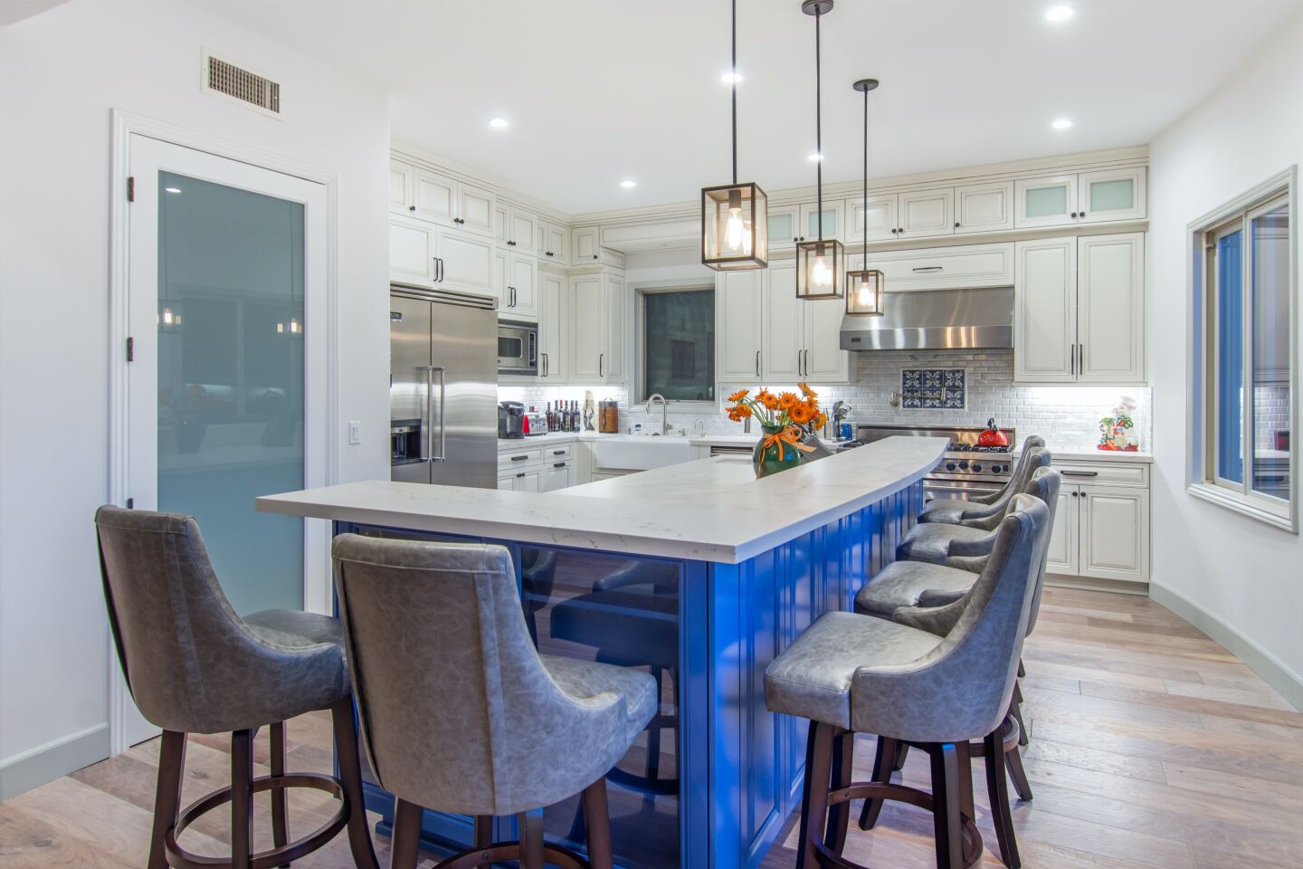 There's seating for six around the bright blue kitchen island.
