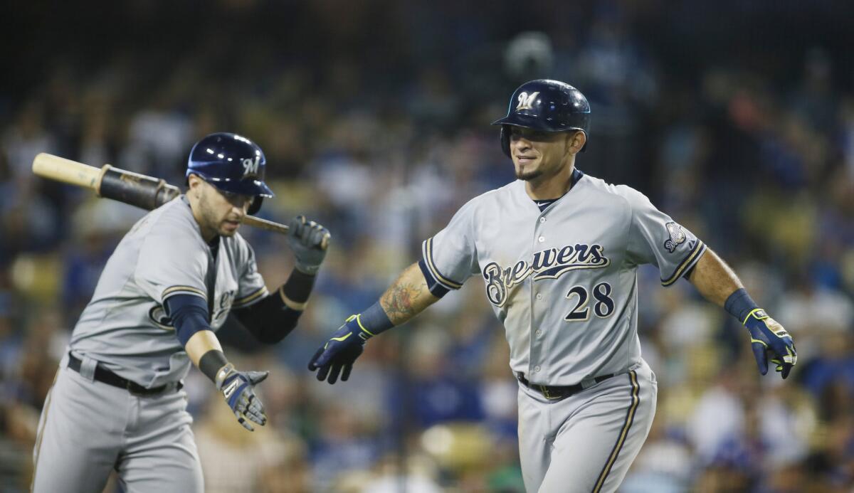 Brewers left fielder Gerardo Parra is congratulated by teammate Ryan Braun after hitting a home run against the Dodgers in the seventh inning Saturday night.