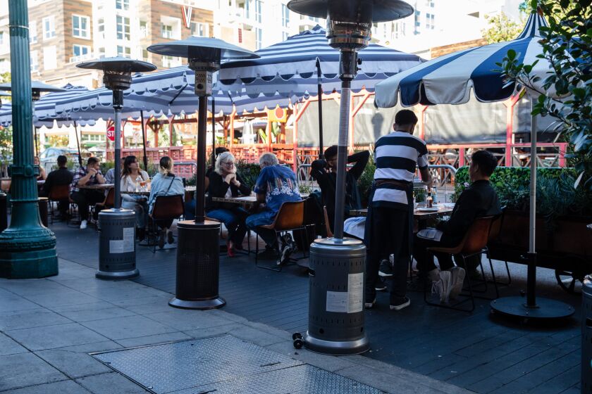 Customers eat meals outside Ironside Fish and Oyster at Little Italy on Tuesday, Oct. 19, 2021.