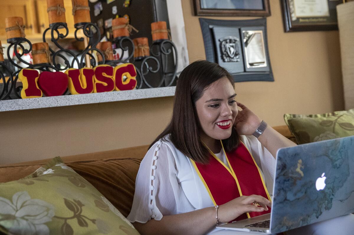 ORANGE, CA - MAY 15: Class of 2020 graduate Maria Morales sets up a Zoom meeting with family members from as far away as Mexico City at home on Friday, May 15, 2020 in Orange, CA. (Brian van der Brug / Los Angeles Times)