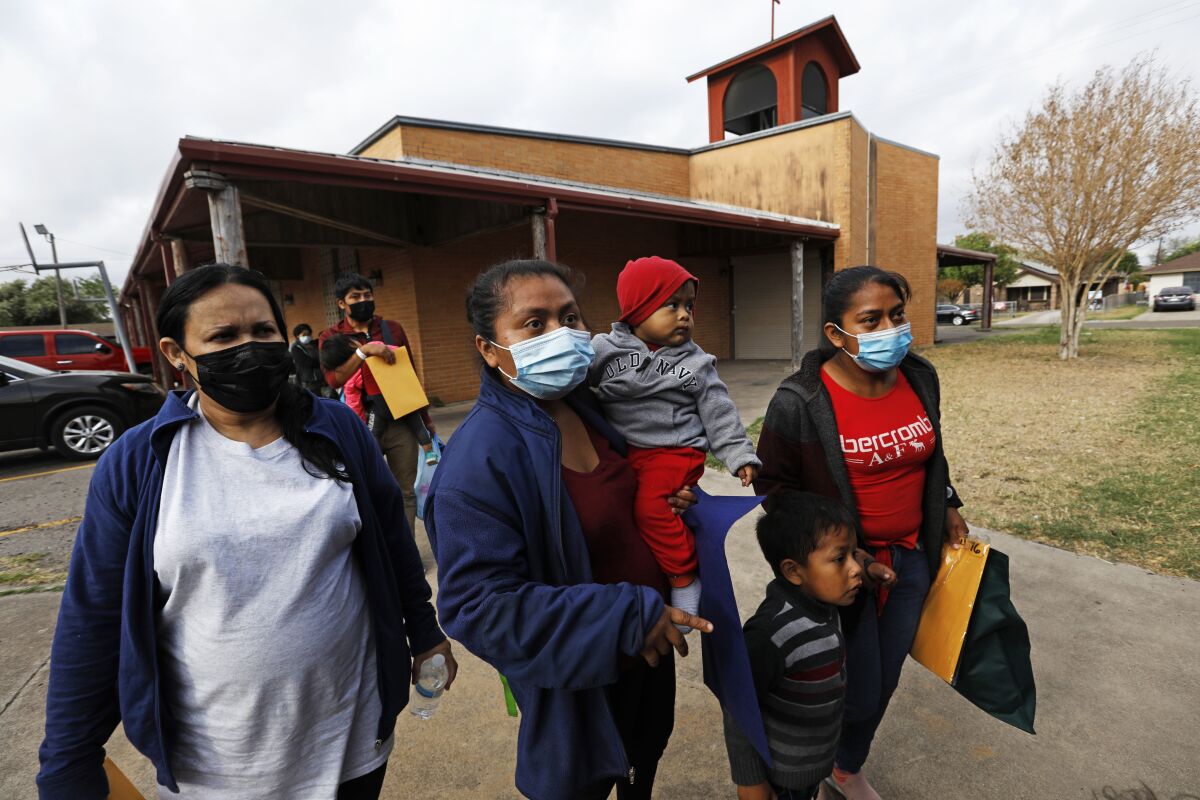 Migrant women and children get ready to board buses in Mission, Texas.  