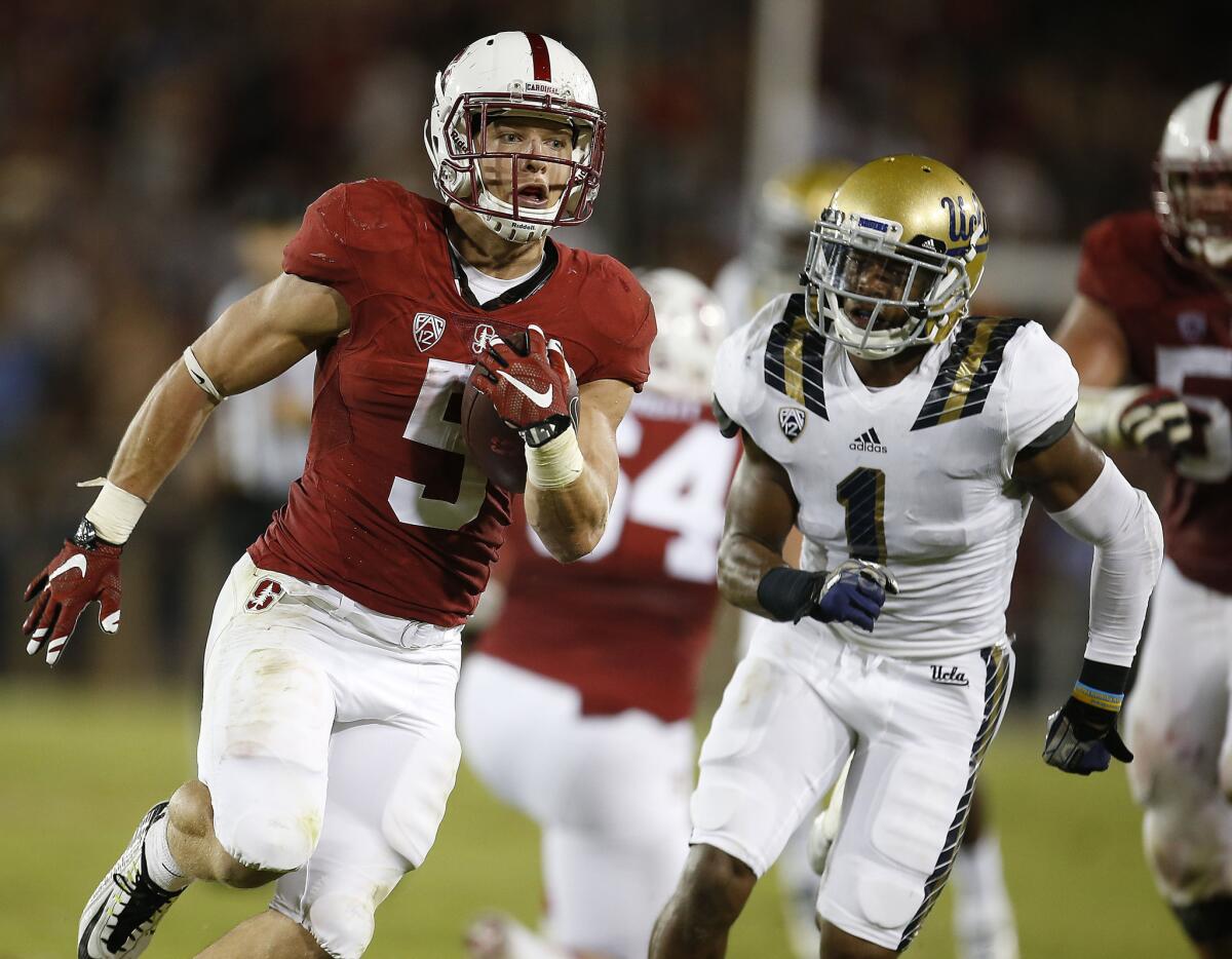 Stanford running back Christian McCaffrey runs past UCLA defensive back Ishmael Adams for a touchdown during the first half on Thursday.