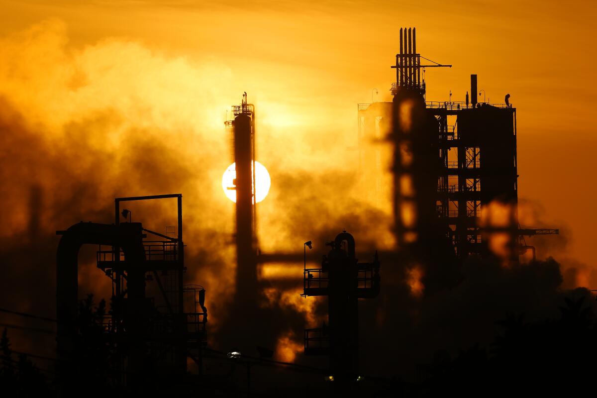 An oil refinery looms over the Wilmington neighborhood of Los Angeles. 